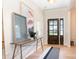 Inviting entryway with wood floors, stylish console table, modern art, and an elegant wooden door at 7930 Rolling Wheels Rd, Charlotte, NC 28215