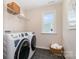 Convenient laundry room featuring a front-load washer and dryer set and storage baskets at 7930 Rolling Wheels Rd, Charlotte, NC 28215