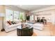Bright and airy living room flows into the kitchen and dining area, with a comfortable sectional at 7930 Rolling Wheels Rd, Charlotte, NC 28215