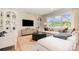 Cozy living room with large window, plush sectional sofa, built-in shelves, and modern decor at 7930 Rolling Wheels Rd, Charlotte, NC 28215