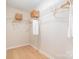 Spacious walk-in closet with wood floor and wire shelving for organized storage at 7930 Rolling Wheels Rd, Charlotte, NC 28215