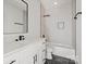Modern bathroom featuring marble vanity, matte black fixtures, and a shower/tub combo with tiled walls at 8632 Cedarbrook Dr, Charlotte, NC 28215
