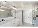 Modern bathroom featuring a double marble vanity, matte black fixtures, and a walk-in shower at 8632 Cedarbrook Dr, Charlotte, NC 28215