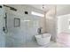 Modern bathroom featuring a soaking tub and shower with glass surround and matte black fixtures at 8632 Cedarbrook Dr, Charlotte, NC 28215