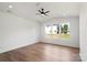 Bright bedroom features hardwood floors, a modern ceiling fan, and large windows offering ample natural light at 8632 Cedarbrook Dr, Charlotte, NC 28215