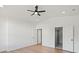 Bright bedroom features hardwood floors, a modern ceiling fan, and includes two doorways at 8632 Cedarbrook Dr, Charlotte, NC 28215