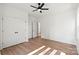 Clean, minimalist bedroom featuring light-colored flooring, a ceiling fan, and a closet at 8632 Cedarbrook Dr, Charlotte, NC 28215