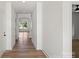 Inviting entryway with hardwood floors, white walls, and views into other rooms at 8632 Cedarbrook Dr, Charlotte, NC 28215