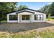Charming home featuring white siding, black trim, large windows, and a covered front porch at 8632 Cedarbrook Dr, Charlotte, NC 28215