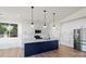Modern kitchen featuring a navy island, stainless appliances, and bright white cabinets at 8632 Cedarbrook Dr, Charlotte, NC 28215