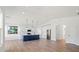 Open-concept kitchen with a blue island, white cabinets, stainless steel appliances, and modern pendant lighting at 8632 Cedarbrook Dr, Charlotte, NC 28215