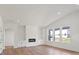 Bright living room featuring hardwood floors, white walls, recessed lighting, and a modern fireplace at 8632 Cedarbrook Dr, Charlotte, NC 28215