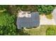 Aerial view showcases a backyard patio, lush landscaping and mature tree coverage at 1004 Gracebrook Dr, Salisbury, NC 28147