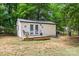 Backyard shed featuring french doors, a small porch and surrounding greenery at 1004 Gracebrook Dr, Salisbury, NC 28147