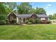 Charming brick and vinyl home with manicured lawn, lush landscaping, and inviting front porch at 1004 Gracebrook Dr, Salisbury, NC 28147