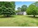 Spacious front yard with mature trees and a charming home with well-maintained landscaping at 1004 Gracebrook Dr, Salisbury, NC 28147