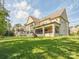 Expansive backyard with a well-manicured lawn and a glimpse of the home's covered patio at 1008 Ladera Dr, Waxhaw, NC 28173