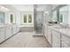 Spa-like bathroom with double vanities, soaking tub with tile surround, and luxurious glass-enclosed shower at 1008 Ladera Dr, Waxhaw, NC 28173