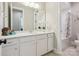 Bathroom featuring a marble sink, white cabinets, toilet, large mirror, and shower-tub combo with curtain at 1008 Ladera Dr, Waxhaw, NC 28173
