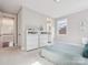 Bright bedroom with plush carpet, fresh paint, a window, and two dressers with modern decor on top at 1008 Ladera Dr, Waxhaw, NC 28173