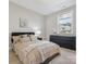 Bedroom featuring a large bed, a dark dresser, carpet, modern decor, and a window with a view at 1008 Ladera Dr, Waxhaw, NC 28173