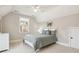 Cozy bedroom with neutral walls, a window, carpet, queen bed with decorative pillows, and a ceiling fan at 1008 Ladera Dr, Waxhaw, NC 28173