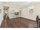 Versatile bonus room featuring hardwood floors, abundant natural light, and built-in bookcases, perfect for various uses at 1008 Ladera Dr, Waxhaw, NC 28173