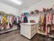 Walk-in closet with custom shelving, drawers, and ample storage space for clothes and accessories at 1008 Ladera Dr, Waxhaw, NC 28173
