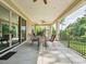 Spacious covered patio with ceiling fan and outdoor dining set, perfect for entertaining at 1008 Ladera Dr, Waxhaw, NC 28173