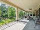 Inviting covered patio with dining seating overlooking the lush green yard at 1008 Ladera Dr, Waxhaw, NC 28173