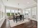Inviting dining room with large windows, modern lighting, and adjacent access to a sunroom at 1008 Ladera Dr, Waxhaw, NC 28173