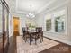 Dining room with hardwood floors, chandelier, and tray ceiling at 1008 Ladera Dr, Waxhaw, NC 28173