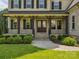 Welcoming front porch with dark wood posts and iron railing at 1008 Ladera Dr, Waxhaw, NC 28173