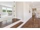 Bright hallway with hardwood floors, fresh paint, access to a bedroom and living room, and recessed lighting at 1008 Ladera Dr, Waxhaw, NC 28173