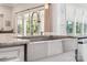 Gourmet kitchen island featuring a stainless steel sink, granite countertop, and modern faucet at 1008 Ladera Dr, Waxhaw, NC 28173