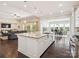 Bright, open kitchen with granite island, stainless appliances, and seamless flow to living and dining area at 1008 Ladera Dr, Waxhaw, NC 28173