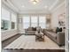 Cozy living room with tray ceiling, neutral paint, and lots of natural light at 1008 Ladera Dr, Waxhaw, NC 28173