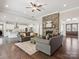 Spacious living room featuring a stone fireplace and hardwood floors at 1008 Ladera Dr, Waxhaw, NC 28173