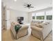 Bright living room features plush sofas, a ceiling fan, and large windows offering natural light at 1008 Ladera Dr, Waxhaw, NC 28173