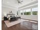 Spacious main bedroom boasts tray ceilings, hardwood floors, and an abundance of natural light with large windows at 1008 Ladera Dr, Waxhaw, NC 28173