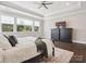 Relaxing main bedroom featuring plush bedding, hardwood floors, and ample natural light from the oversized windows at 1008 Ladera Dr, Waxhaw, NC 28173