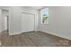 Comfortable bedroom features vinyl flooring, large window, and sizable closet at 1016 Confederate S Ave, Rock Hill, SC 29732