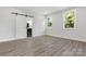 Bedroom features modern sliding barn door and natural light from large windows at 1016 Confederate S Ave, Rock Hill, SC 29732