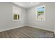 This airy bedroom boasts sleek vinyl floors and two large windows, creating a serene space at 1016 Confederate S Ave, Rock Hill, SC 29732