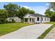 A view of the home showcasing the long driveway, fresh lawn, and a neighboring building at 1016 Confederate S Ave, Rock Hill, SC 29732