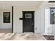 A close-up of the front door showcasing modern design, a sidelight window, and white siding at 1016 Confederate S Ave, Rock Hill, SC 29732