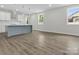 Modern kitchen featuring stainless steel appliances, white cabinets, gray kitchen island and stylish backsplash at 1016 Confederate S Ave, Rock Hill, SC 29732