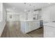 Open-concept layout with an island kitchen, stainless steel appliances, and hardwood floors at 1016 Confederate S Ave, Rock Hill, SC 29732