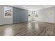 Spacious living room features an accent wall, hardwood floors, and natural light from large windows at 1016 Confederate S Ave, Rock Hill, SC 29732