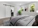 Bright main bedroom featuring stylish decor, barn door to en-suite, and large windows at 1016 Confederate S Ave, Rock Hill, SC 29732